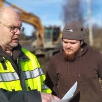 Valvoja Martti Lautala ja TKT Urakointi Oy:n Janus Veckman tarkastelevat, miten vettä kosteikoissa pitävät pohjapadot rakennetaan ja muotoillaan.